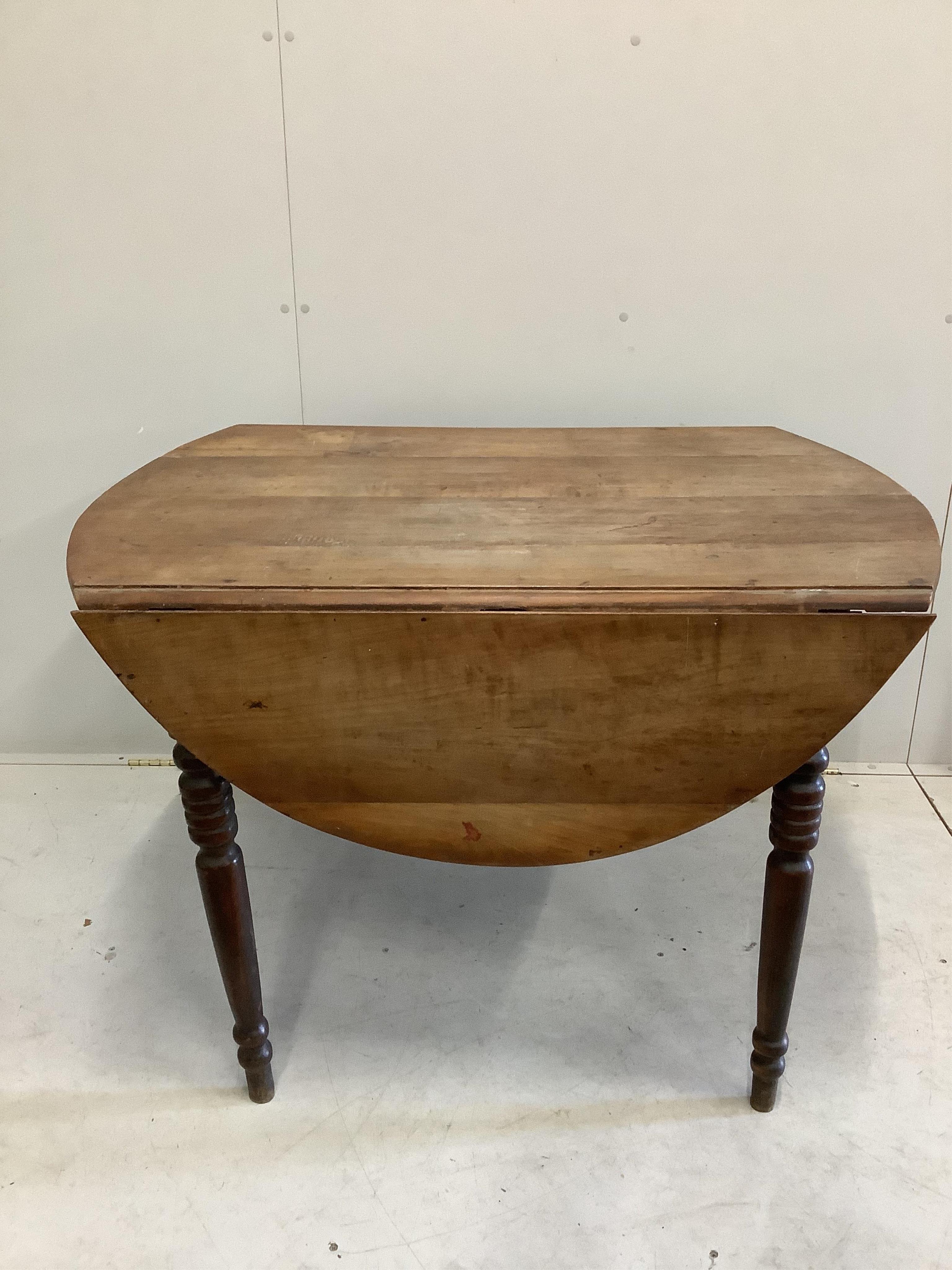 A large 19th century French cherry drop leaf dining table, width 112cm, 142cm extended, height 73cm. Condition - poor to fair